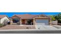 Charming single-story home with well-maintained landscaping and a two-car garage at 7805 Leavorite Dr, Las Vegas, NV 89128