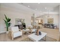 Inviting living room with light wood floors and comfortable seating arrangement at 7805 Leavorite Dr, Las Vegas, NV 89128
