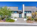 Modern home with sleek architectural lines, desert landscaping, and stylish entrance showcasing contemporary design at 787 Keyland St, Las Vegas, NV 89138