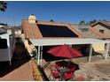 Backyard patio with shade and outdoor dining next to an RV and a solar panel array at 837 Holly Lake Way, Henderson, NV 89002