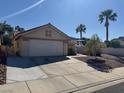 Single story home showcasing a desert-landscaped front yard and a wide driveway to the garage at 837 Holly Lake Way, Henderson, NV 89002