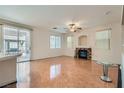 Spacious living room features a fireplace, ceiling fan, and sliding glass doors to the backyard at 89 Autumn Day St, Henderson, NV 89012