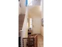 Entryway with tiled flooring, a staircase, a safety gate, and a white door at 8913 Cambridge Glen Ct, Las Vegas, NV 89149