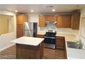Bright kitchen featuring a center island, stainless appliances, and ample cabinet space at 8982 Leaping Pad Ct, Las Vegas, NV 89148