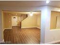 Open-concept living room with hardwood floors and plenty of natural light at 8982 Leaping Pad Ct, Las Vegas, NV 89148