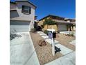 Charming two-story home with a well-maintained front yard, concrete driveway, and a two-car garage at 9082 Amanda Creek Ct, Las Vegas, NV 89149