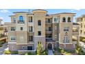 Multi-story condominium building with beige stucco exterior, balconies, and well-maintained landscaping at 9125 Las Manaitas Ave # 302, Las Vegas, NV 89144