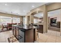 Bright kitchen with an island, granite countertops, stainless steel appliances, and an open dining area at 9362 Wilderness Glen Ave, Las Vegas, NV 89178