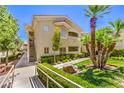 Two story condo exterior with desert landscaping, stairs and balcony at 10109 Jacob Pl # 203, Las Vegas, NV 89144