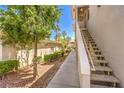 Exterior view of a condominium building with well-maintained landscaping and easy access to stairways at 10109 Jacob Pl # 203, Las Vegas, NV 89144
