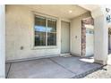 A front porch and door featuring stone detail on the entryway at 10230 Viterbo St, Las Vegas, NV 89183