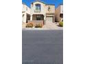 Charming two-story townhome with desert landscaping and an attached one car garage at 10230 Viterbo St, Las Vegas, NV 89183