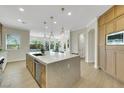 Spacious kitchen with a central island, stainless steel appliances, and custom wood cabinetry at 10277 Roma Madre Ave, Las Vegas, NV 89135