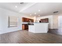 Bright living room view of kitchen area with modern finishes and sleek wood flooring at 10458 Gabaldon St, Las Vegas, NV 89141