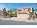 Two-story home with a large front yard, desert landscaping, and an attached two-car garage at 10948 Carberry Hill St, Las Vegas, NV 89141