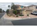 A quiet street view showcases a landscaped corner property with a two-story home and tile roof at 10948 Carberry Hill St, Las Vegas, NV 89141