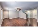 Spacious living room featuring sleek hardwood floors, a ceiling fan, and ample natural light at 11177 Deluna St, Las Vegas, NV 89141
