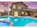 Enjoy the pool and hot tub with an outdoor dining space, great for entertaining, by the covered patio at 1200 Dream Bridge Dr, Las Vegas, NV 89144