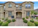 Inviting townhome exterior with well-maintained landscaping and a brick walkway leading to the front door at 1200 Paradise Basin Ct, Henderson, NV 89002