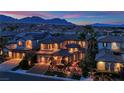 Beautiful home featuring lush landscaping and exterior lighting at 1972 Alcova Ridge Dr, Las Vegas, NV 89135