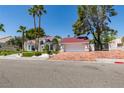View of the front exterior showing the red-tiled roof, driveway and garage framed by mature palm trees and landscaping at 2101 Diamond Bar Dr, Las Vegas, NV 89117