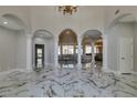 Grand foyer featuring soaring ceilings, marble floors, and an open floor plan with decorative columns and arches at 2101 Diamond Bar Dr, Las Vegas, NV 89117