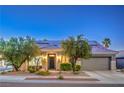 Beautiful single-story home featuring desert landscaping, solar panels, and a two-car garage at 2158 High Mesa Dr, Henderson, NV 89012