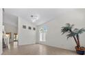 Bright living area with large window, neutral tile flooring, and ample space for relaxation and entertaining at 2329 Sunrise Meadows Dr, Las Vegas, NV 89134