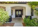 Inviting front entrance with double doors and manicured landscaping at 25 Blue Valley Dr, Henderson, NV 89002