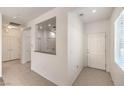 Inviting entryway features tile floors, neutral paint, and a clear view into the kitchen area at 2550 Evening Twilight Ave, Henderson, NV 89044