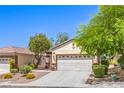 Inviting home featuring desert landscaping and a two-car garage at 2550 Evening Twilight Ave, Henderson, NV 89044