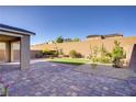 A spacious backyard is highlighted by a brick-paved patio area and neatly arranged landscaping at 2628 Ferrara St, Henderson, NV 89044