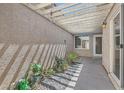 Serene covered courtyard with a pebble garden and lush plants, offering a private outdoor retreat at 2668 Ivoryhill St, Las Vegas, NV 89135