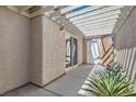 Charming outdoor patio area with a pergola-covered area and desert landscaping at 2668 Ivoryhill St, Las Vegas, NV 89135