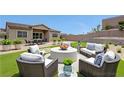 Outdoor patio with dining and seating areas offers a relaxed living space at 281 Gandara St, Las Vegas, NV 89138