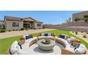Inviting outdoor seating area with plush cushions, perfect for entertaining in the landscaped backyard at 281 Gandara St, Las Vegas, NV 89138