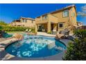 Backyard featuring a beautiful pool with rock accents and an outdoor seating area at 29 Blue Valley Dr, Henderson, NV 89002