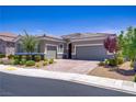 Beautiful home featuring a paver driveway, desert landscaping, and a two-car garage at 3155 Dalmazia Ave, Henderson, NV 89044