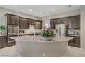 A gourmet kitchen featuring stainless appliances, a large island and gorgeous countertops at 3155 Dalmazia Ave, Henderson, NV 89044