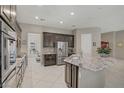 A gourmet kitchen featuring stainless appliances, a large island and gorgeous countertops at 3155 Dalmazia Ave, Henderson, NV 89044