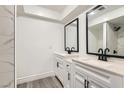 Bright bathroom featuring modern vanity with dual sinks and a sleek black faucet design at 3310 Heritage Pl, Las Vegas, NV 89121