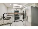 Bright kitchen with stainless steel appliances, granite counters, and undermount sink at 3310 Heritage Pl, Las Vegas, NV 89121
