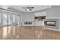 Spacious living room with hardwood floors, fireplace, and open layout to kitchen at 4227 Pacifico Ln, Las Vegas, NV 89135