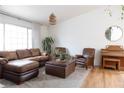 Inviting living room featuring a comfortable leather sofa, armchairs, and wood-look flooring at 5400 Tassara Way # 106, Las Vegas, NV 89108