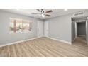 Bright bedroom featuring wood floors, a ceiling fan, a window, and neutral paint at 5817 Glen Eagles Ln, Las Vegas, NV 89108