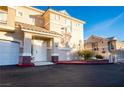 Exterior of a well-maintained two-story home with attached garages and manicured landscaping at 5855 Valley Dr # 2161, North Las Vegas, NV 89031