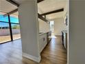 Modern kitchen with stainless steel appliances, ample counter space, stylish cabinets, and wood-look flooring at 6261 Rassler Ave, Las Vegas, NV 89107