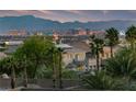 Beautiful home featuring lush landscaping and a stunning backdrop of the cityscape and mountains at 6999 Stone Meadows Ave, Las Vegas, NV 89142