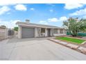 Charming single-story home featuring a well-maintained front yard and a gray color scheme at 721 Carpenter Dr, Las Vegas, NV 89107
