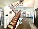 Bright foyer with wood floors, staircase, decorative accents, and an open floor plan at 7400 Amigo St, Las Vegas, NV 89123
